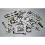 A selection of silver items and collectables including a buckle, various pairs of sugar tongs, small