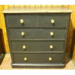 A Victorian black-painted large pine chest of two short and three long graduated drawers with