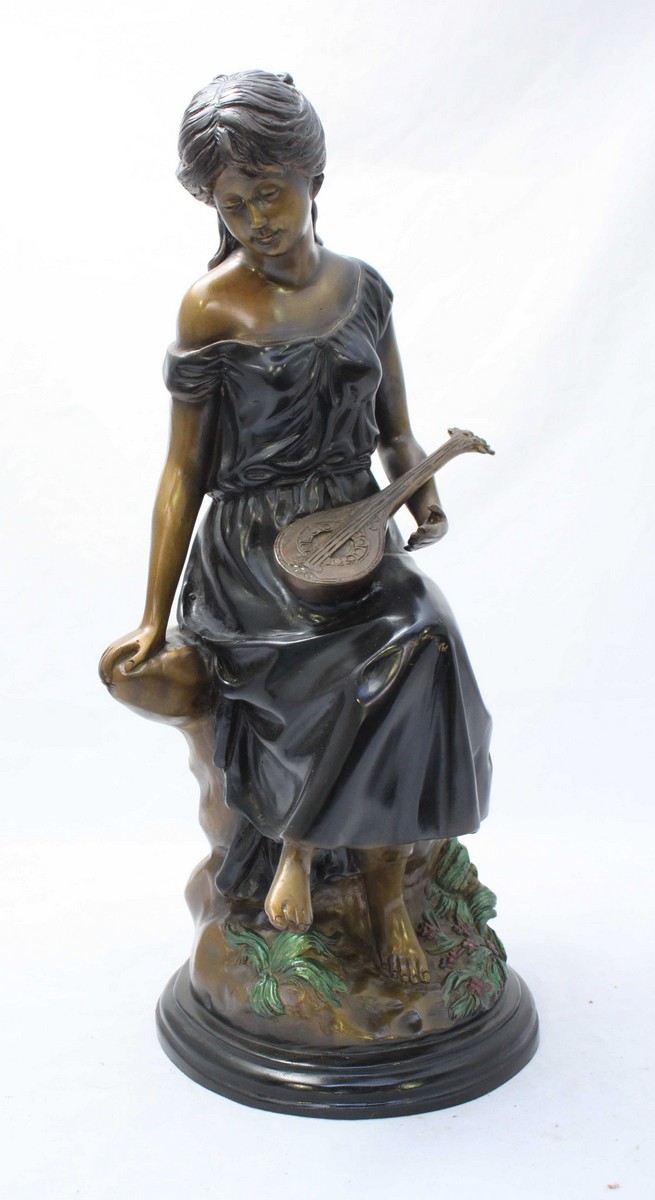 A patinated and painted bronze figure of a seated lady with a mandolin, approximately 47cm high