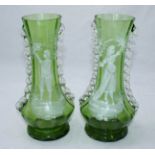 A pair of 19th century mould-blown green glass vases of baluster form, decorated with a boy and a