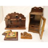 An early 20th century oak smokers cabinet and a carved wood pipe rack and various pipes, together