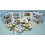 Approximately two hundred and sixty lithographic and photographic postcards in three albums and some