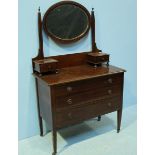 An Edwardian dressing table with central oval mirror flanked by two small inlaid drawers, above