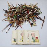 A large quantity of lace bobbins including wooden and bone, and a set of Happy Family playing cards