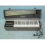 A Lorenzo Portable Reed Organ, with three octaves and detachable legs. 64cm wide.