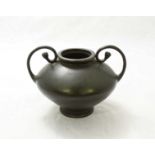 A small Chinese bronze two handled bowl with character mark to base. 12cm high.