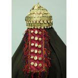 An Afghan or Turkmenistan wedding headdress embroidered with seashells and metal plating