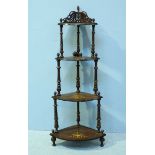 A four-tier Victorian rosewood corner waterfall whatnot with floral inlay. 147cm wide.