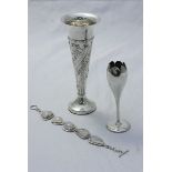 Two silver spill vases, one of tapering cylindrical form with floral moulded decoration, together