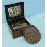 A late 19th/early 20th century Nicole Freres Polyphon in inlaid walnut case, the lid lifting to