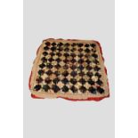 Log cabin design quilt, probably English, early 20th century, 80in. 206cm. sq. With machine net