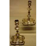 A pair of George II silver cast candlesticks, with four shell corners, the spool turned