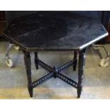 A Victorian ebonised wood aesthetic centre table, the octagonal top with a moulded edge, an enamel