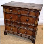 A late seventeenth century oak chest of four long graduated drawers, pine lined with moulded