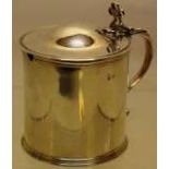 A George III silver circular mustard pot, with a hinged domed lid, a pierced thumbpiece to a