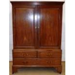 A mid eighteenth century mahogany gentleman's wardrobe, the cavetto moulded cornice above a