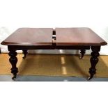A Victorian mahogany extending dining table, the rectangular top with three extra leaves, the