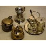 An Edwardian silver circular condiment cruet, with three cut glass fittings, two with silver lids.