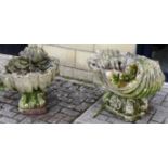 A pair of reconstituted stone scallop shell garden ornaments, 28in (71cm) long 16in (40cm) high,