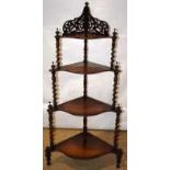 A Victorian rosewood corner etagere, the four serpentine fronted graduated shelves on front spiral