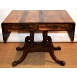 A George IV rosewood veneered sofa table, the drop leaf top above two frieze drawers in front and