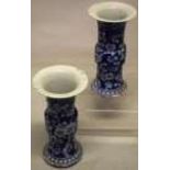 A pair of Chinese porcelain blue and white ku shape vases, decorated prunus blossom, (one chipped)