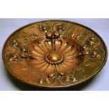 A French Belle Epoque repousse copper charger, a central boss with beaded circlet, fluting to a