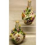 A pair of William IV marked Coalport porcelain vases, encrusted with flowers and gilded branches.
