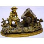 A mid nineteenth century amusing bronze and gilt bronze inkstand, the inkwell with hinged cover,