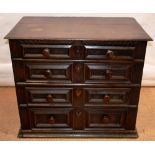 A seventeenth century oak chest of four long graduated drawers, with panelled fronts on side