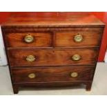 An early nineteenth century mahogany veneered chest, inlaid stringing, the two short and two long