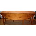 An Irish cherrywood wake table, the elongated drop leaf top on square tapering gatelegs. 6ft 2in (