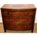 An early nineteenth century mahogany veneered dressing commode chest, of three long drawers, with