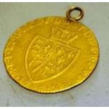 A 1787 guinea with later gold fob ring.