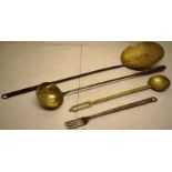 A late eighteenth century brass skimmer with wrought iron handle, 26.5in (62cm) a brass bowl ladle