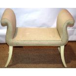 An upholstered window seat, on cream painted sabre legs. 35in (89cm)