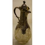 A late Victorian cut glass claret jug, with lobed cut panels, the foot chipped, the neck with a