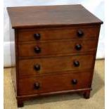 An early nineteenth century oak bedside commode, the lift up front with four dummy drawers, with