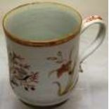 A mid eighteenth century Chinese export porcelain quart mug, decorated an urn of flowers and