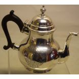 A George I silver teapot, the pear shape body engraved a coat of arms, possibly of the Judge