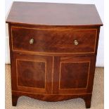 A Regency mahogany bow front bedside cupboard, with a lift up dummy drawer front with brass knob