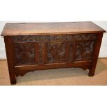 A seventeenth century boarded oak coffer, the lid with iron wire hinges reveals a lidded candle box,