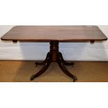 A George IV mahogany breakfast table, the rectangular tilt top with rounded corners, the open
