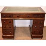 A small Victorian mahogany pedestal desk, the detachable top inset leather, with three frieze