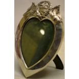 A late Victorian Royal heart shape photograph frame, the silver front with a cresting of the British
