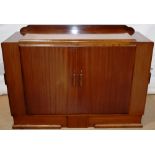 A 1930's mahogany sideboard, the stepped veneered top with a raised back, the front with a