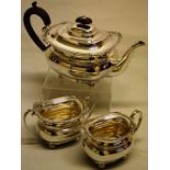 A silver three piece tea service, in Regency style, the rectangular ogee bodies with gadroon