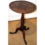 A late eighteenth century elm occasional table, the circular burr figured elm tilt top with a raised