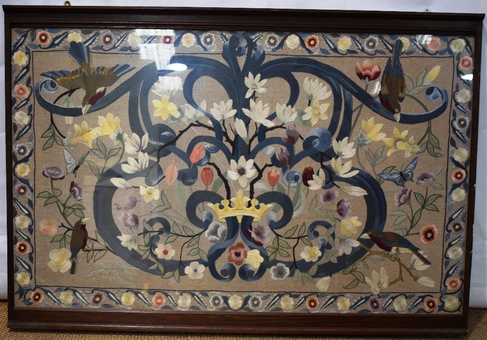 A large silkwork panel on linen, of a gilt countesses coronet set in a blue scrolling cartouche,