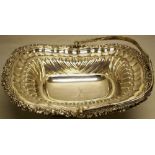 A George IV silver rectangular fruit basket, the centre engraved a crest of a dragon head, the